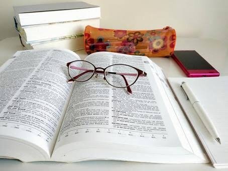 English book opens and glasses on the book